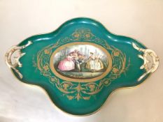 A late 19th century porcelain tray in the Sevres style, of cartouche form, centred by a reserve
