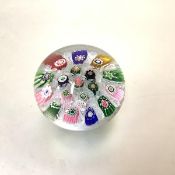 A 19th century paperweight, probably Clichy with central pink rose cane amidst millefiori canes on a