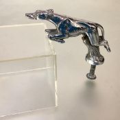 A chromium-plated greyhound car mascot, indistinctly stamped with a number. Length 13cm