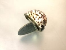 A white-metal mounted cowrie shell snuff, of characteristic form, the hinged cover naively