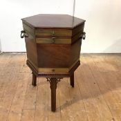A George III mahogany cellarette, of hexagonal outline, late 18th century, the hinged top