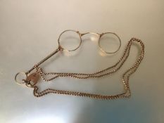A 9ct gold box-link chain with lobster clasp suspending a 9ct gold heart padlock and a gilt-metal