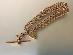 A 9ct gold twin-strand curblink bracelet with heart padlock clasp and safety chain suspending a