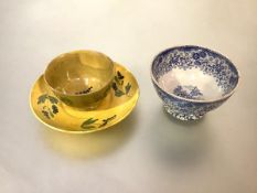 A Scottish pottery cup and saucer, early 19th century, glazed in yellow and painted with green