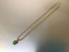 An 18ct gold mounted jadeite pendant, the oval cabochon stone in a conforming mount stamped 