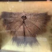 A Chinese woven coconut fibre raincoat or cloak, c. 1900, strikingly mounted in a box frame with