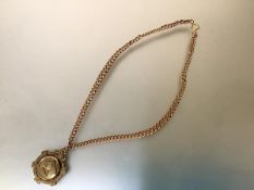 A 9ct gold curblink neck chain suspending a silver-gilt fob chaased with a horse's head. Chain 41.