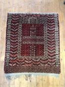 A Persian rug of Hadklu type, the red ground with all-over geometric design centred by a mirhab.