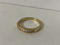 An 18ct gold ring channel set with nine diamonds size Q weighs 4.06grammes