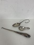 An Edwardian Chester silver caddy spoon with shell shaped bowl, button hook with London silver