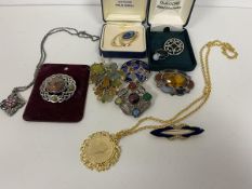 A quantity of costume and silver jewellery including brooches with polished stones, a pendant