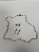 A single strand of graduated cultured pearls with silver clasp measures 23cm along with two pairs of