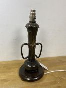 An Art Nouveau metal table lamp with later fixtures of naturalistic form with two handles to side on