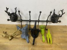 A group of novelty wall hooks including horns, rabbit, rhinoceros, deer and dogs tail also a coat