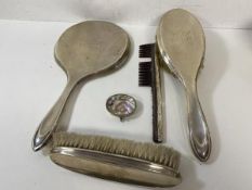 A Birmingham silver dressing table set including a hand mirror measuring 28cm,a hair brush, a