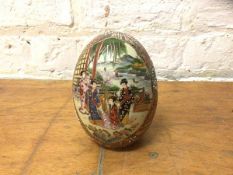 A Satsuma egg shaped table ornament with pair of panels depicting women on verandah playing