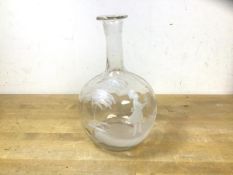 A Mary Gregory clear glass bottle of bulbous form depicting child holding flowers under tree,