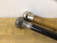 A late 19thc/20thc ebonised walking stick, with silver caps, measure 92cm long, and a Malacca