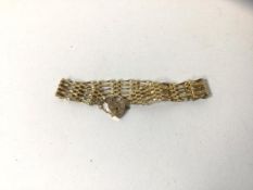 A gate link bracelet complete with padlock locket, both marked 9k, and measure 8cm, combined