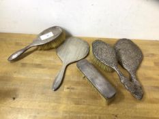 A silver backed dressing table brush set including a 1920's Glasgow silver hairbrush, hand mirror