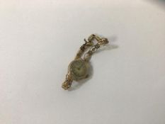 A 1930's ladies wrist watch, the case marked .375, on rolled gold strap