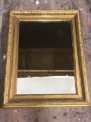 An Edwardian wall mirror, the rectangular glass within a gilt metal frame, measures 61cm x 48cm