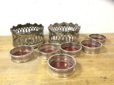 Two white metal wine coasters with raised pierced edges and wooden bases, measure 8cm x 14cm,