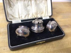 A 1923 Birmingham silver condiment set including two salts, both with blue glass liners, and