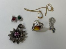 A silver ring with polished pear shaped amber to centre, size P, a silver pendant with purple stones