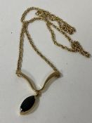 A 9ct gold pendant necklace, the 9ct gold chain with wishbone mount pendant, makers mark MC within