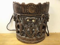 An African carved and pierced back carrier with rope arm straps, figures with mother of pearl