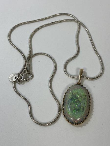 An opal pendant necklace, the oval opal in yellow metal mount on chain marked 925, (pendant - 3cm