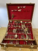A 1970's teak canteen with quantity of bronze utensils including knives, forks, spoons, serving fork