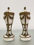A pair of Louis XVI style gilt-metal mounted alabaster cassolettes, each ovoid urn with reversible
