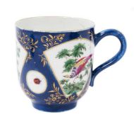 A Worcester large coffee or chocolate cup, painted with exotic birds, on a powder blue ground, circa