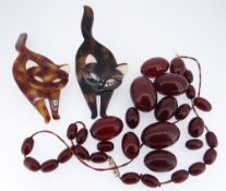 ASSORTED JEWELLERY comprising two similar Lea Stein of Paris cat brooches and a string of cherry