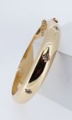 YELLOW METAL BANGLE set with white semi-precious gem stones, 28.5gms Provenance: deceased estate