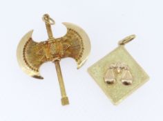 TWO 18CT YELLOW GOLD PENDANTS, one a double sided axe and the other depicting weighing scales,