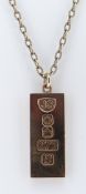 9CT GOLD RECTANGULAR INGOT PENDANT on 9ct gold chain, 62cms long, 42.0gms overall Provenance: