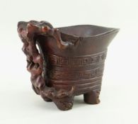 CHINESE CARVED & STAINED BAMBOO LIBATION CUP, simulating Rhinoceros horn, 10cms high Comments: