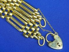 NINE CARAT GOLD GATE LINK BRACELET with padlock clasp and textured decoration to the outer links
