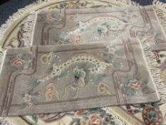 CHINESE WASHED WOOLLEN RUGS (4) to include a circular example, floral patterned with central roundel