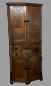 18th CENTURY CORNER CUPBOARD in three sections, the upper section having two fielded panelled