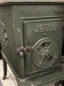 JOTUL GREEN ENAMELLED CAST IRON STOVE with possibly associated flue attachments, 64cms H, 33cms W,