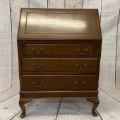 BUREAU - a reproduction mahogany example on pad feet, 104cms H, 74cms W, 44cms D
