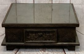 MEXICAN STYLE CARVED COFFEE TABLE - glass topped with drawer to each side on block supports, 32cms