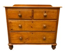 ANTIQUE PINE CHEST of two short over two long drawers, with railback, on bun feet, 103cms H,