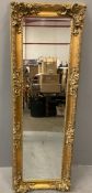 DECORATIVE GILT FRAMED WALL MIRROR with bevelled glass, 170 x 58cms