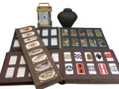 COLLECTOR'S CIGARETTE CARDS in three small albums, London Clock Co Quartz carriage clock and a