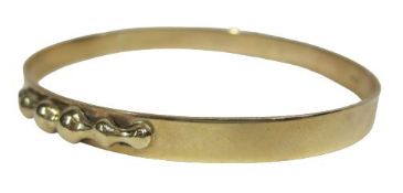 9CT GOLD LADY'S BANGLE - solid with part edge applied decoration, 17.2grms